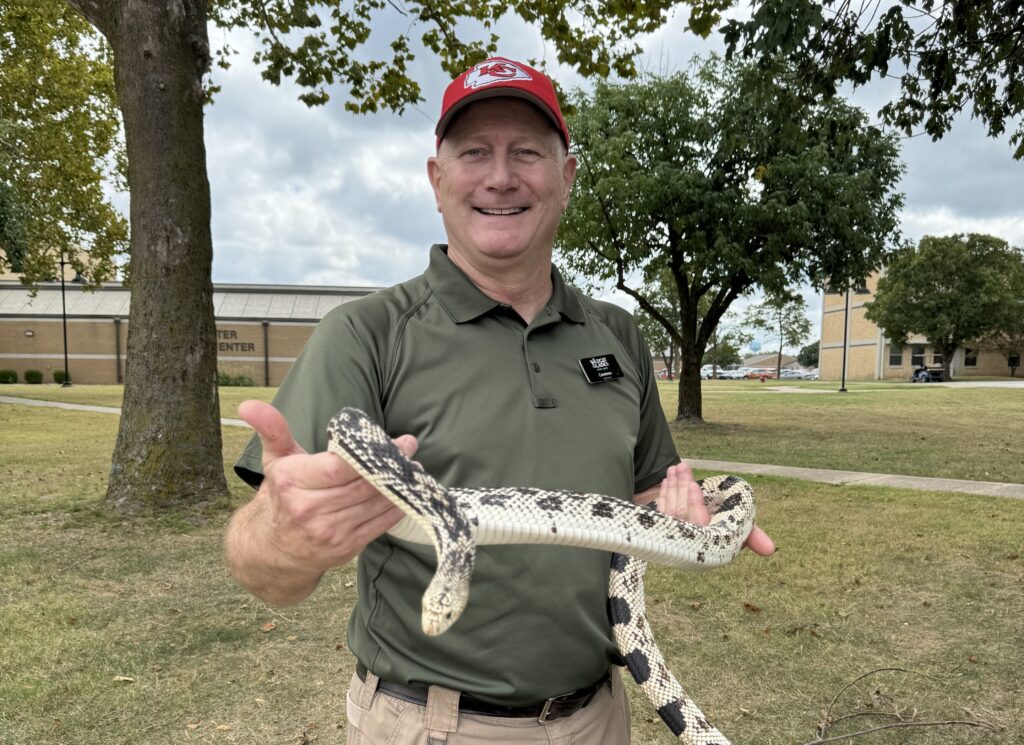 Wildcat Glades Volunteer Cameron Kruse is pictured with his bull snake.